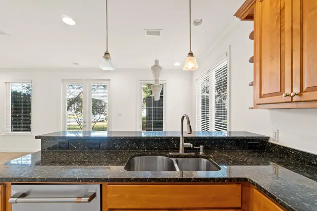 a kitchen with granite countertop a sink and a window