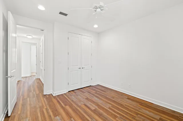 a view of a room with wooden floor and white walls