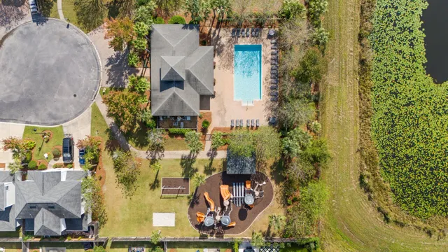 aerial view of a house with a yard and large trees