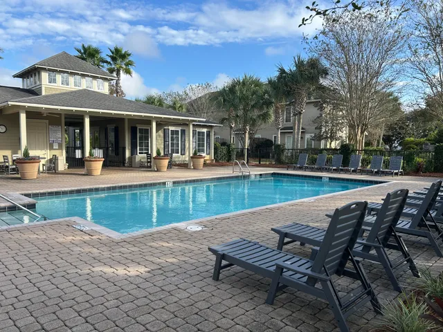 a view of a house with swimming pool and sitting area