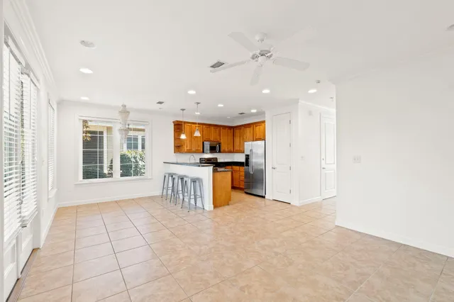 a view of kitchen with stove and cabinets