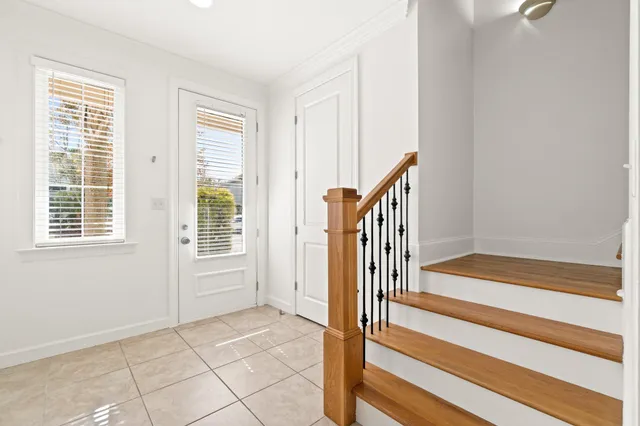 a view of an entryway with wooden floor and door