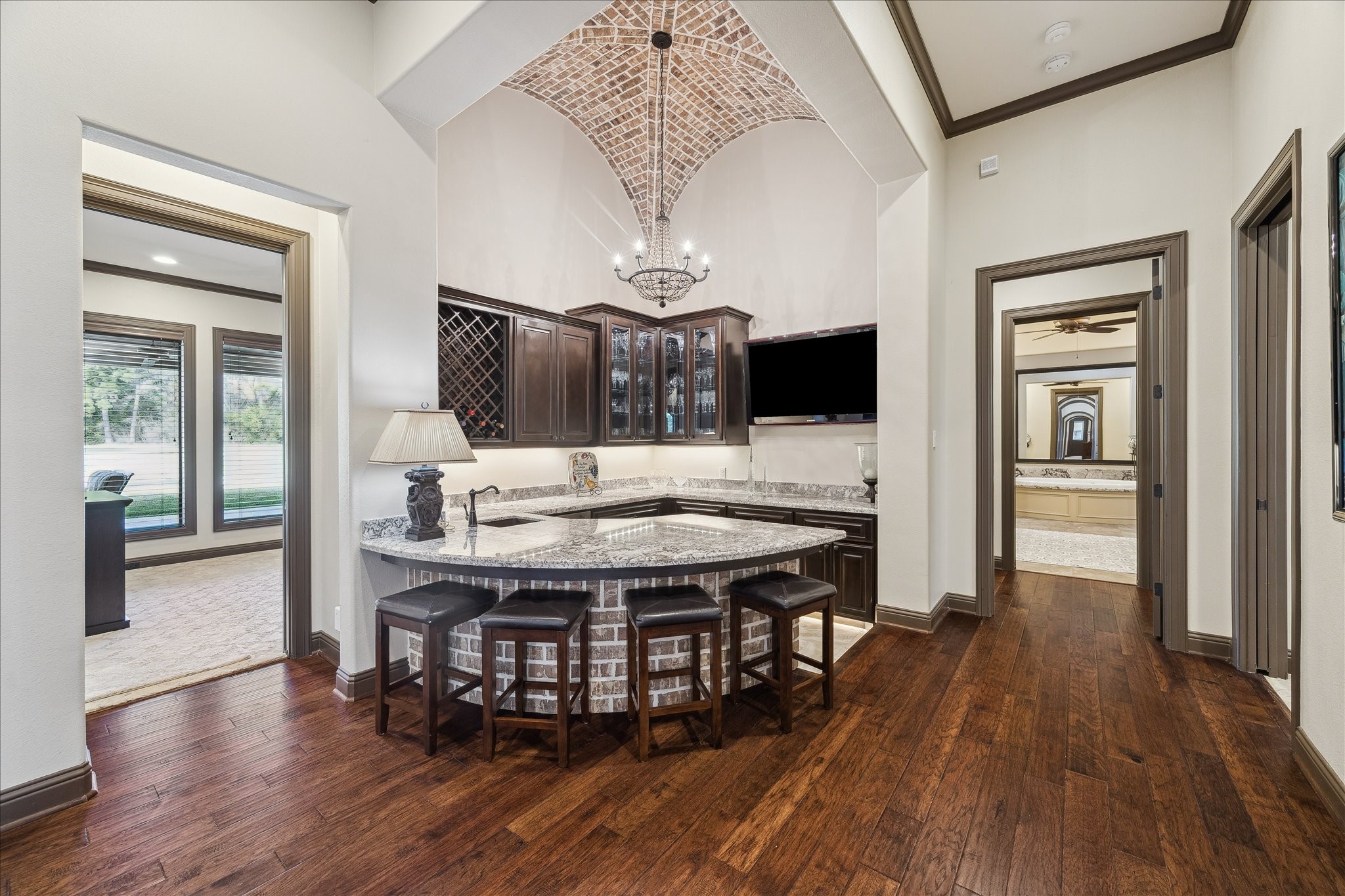 11 Willowcreek Ranch Road Tomball, TX 77377 - Photo 36 of 49 Just off the family room and formal dining room is the built-in bar area, perfect for professional entertainers! The bar is equipped with counter height seating and a mounted flat screen television so no one misses the game!