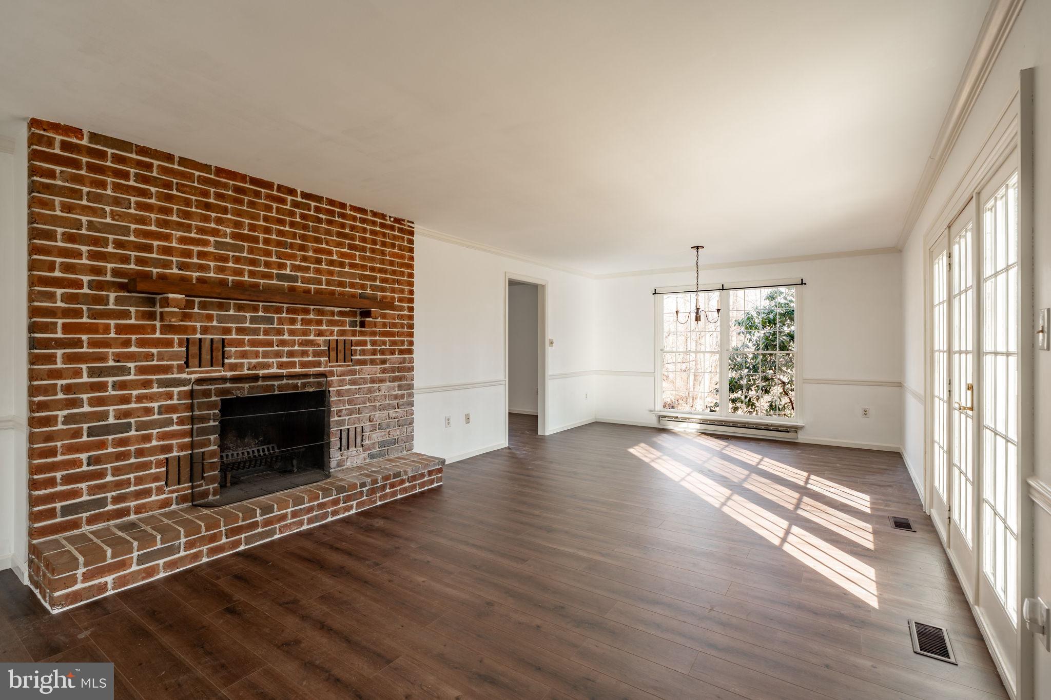 540 Grings Hill Road Reading, PA 19608 - Photo 8 of 43 a view of an empty room with wooden floor fireplace and a window
