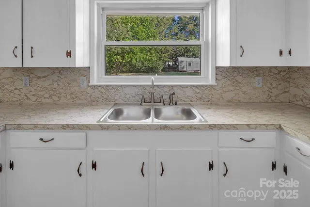 a kitchen with a sink and cabinets