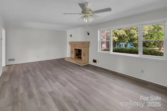 wooden floor in an empty room with a fireplace