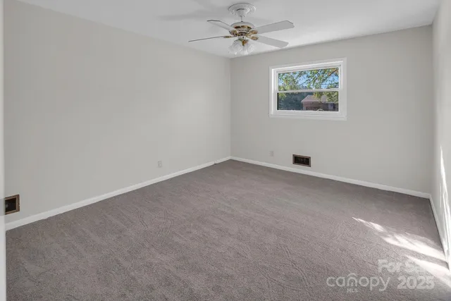 an empty room with a painting on the wall