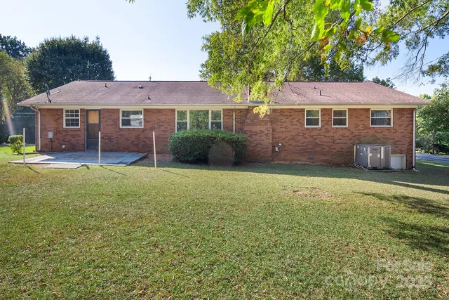 a front view of a house with a garden and yard