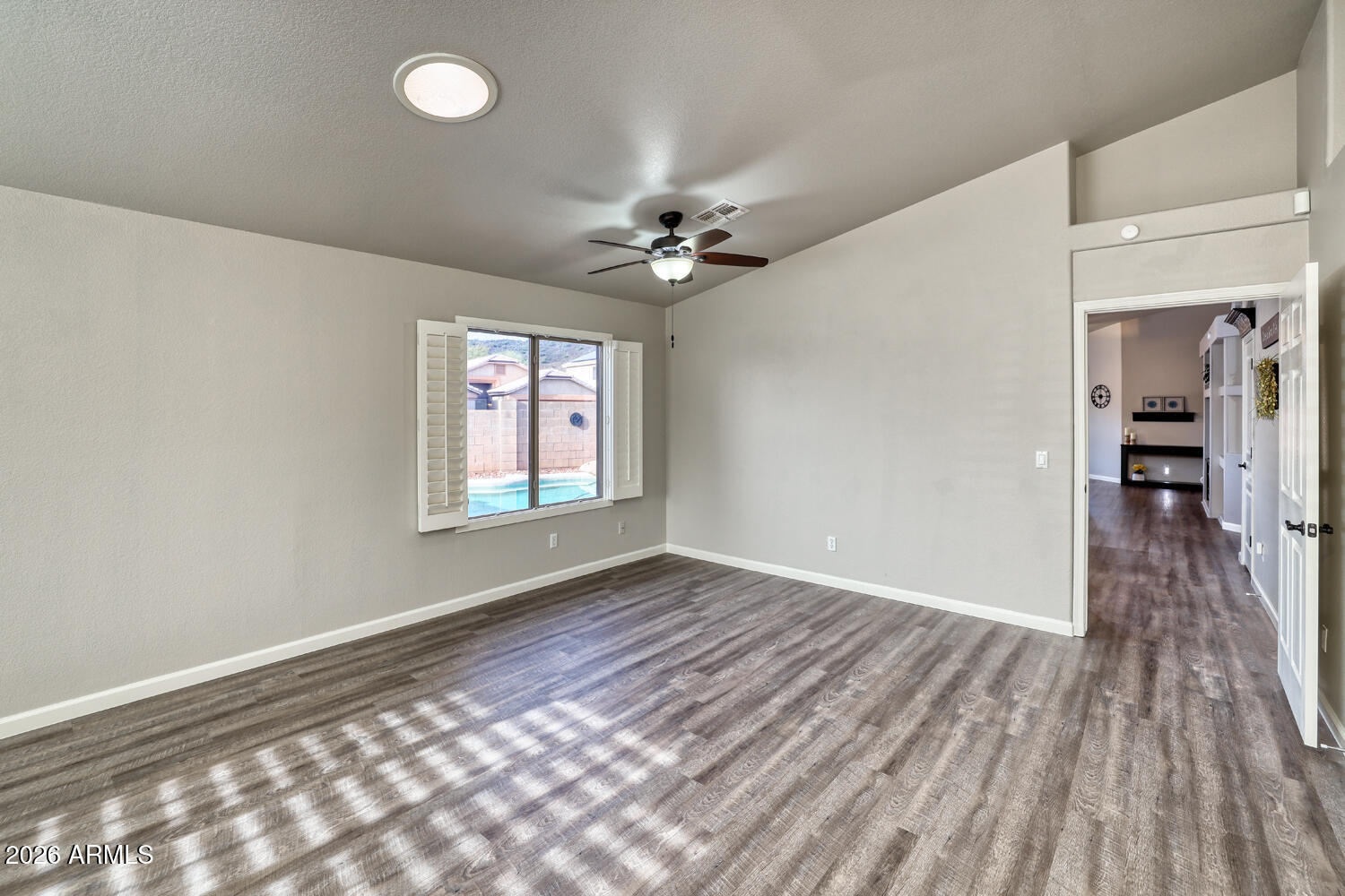2206 East Ruby Lane Phoenix, AZ 85024 - Photo 4 of 29 wooden floor in an empty room with a window