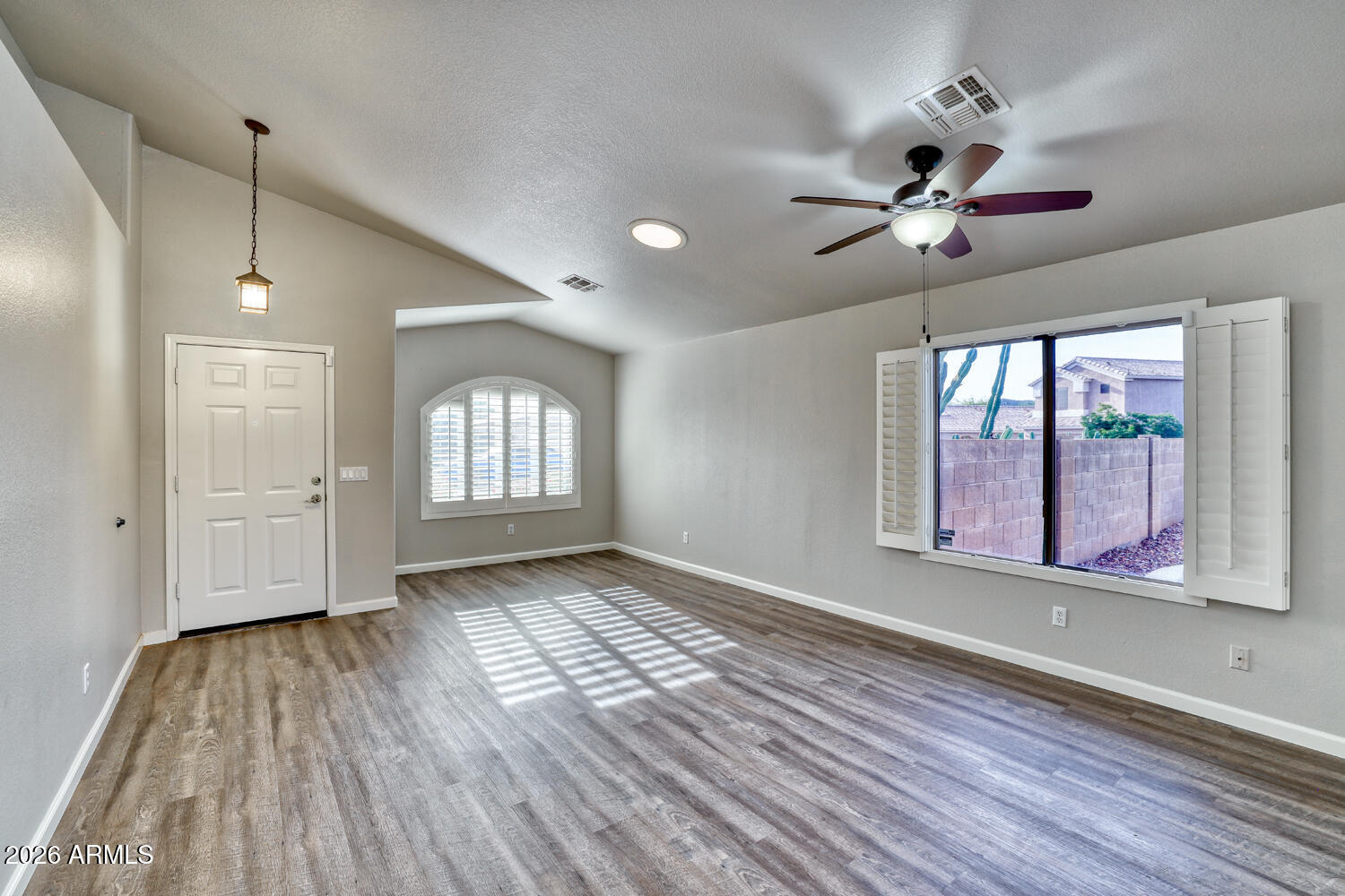 2206 East Ruby Lane Phoenix, AZ 85024 - Photo 5 of 29 a view of an empty room window and wooden floor
