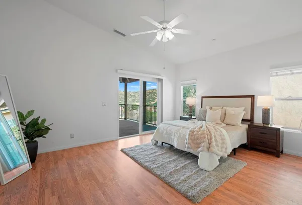 a bedroom with a large bed and a window