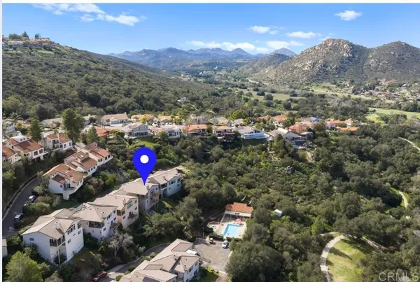 an aerial view of lake and residential houses with outdoor space