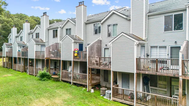a view of a house with a yard and sitting area
