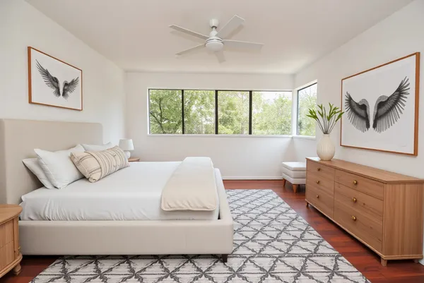 a bedroom with a bed and a painting on the wall
