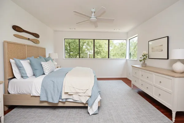 a spacious bedroom with a bed and a chandelier