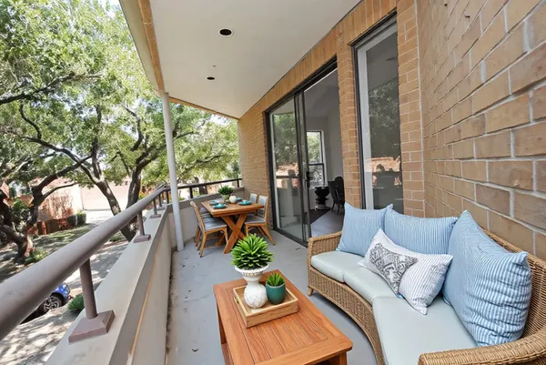 a balcony with furniture and a large window