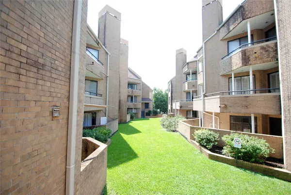 a view of a building with a yard