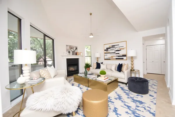 a living room with furniture a fireplace and a table