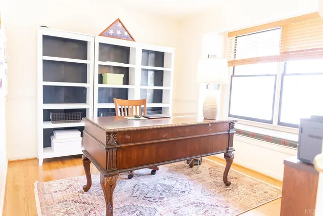 a room with a table and a window with wooden floor