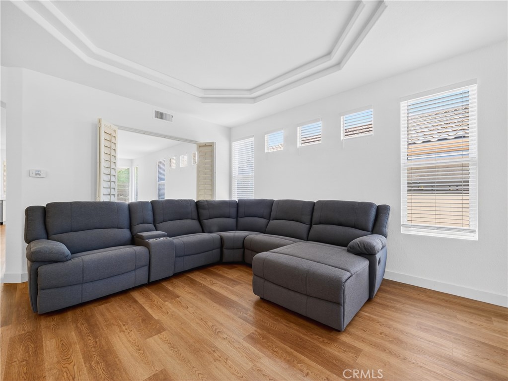 1436 Riviera Avenue Banning, CA 92220 - Photo 21 of 43 a living room with furniture and a wooden floor