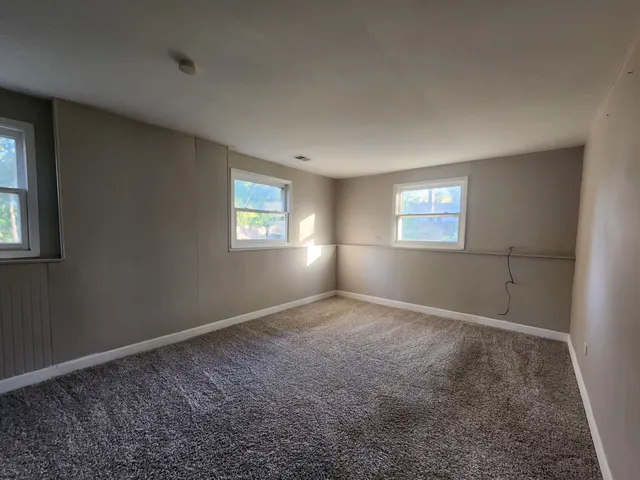 a view of an empty room with windows