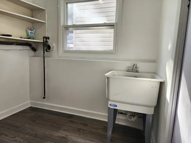 a room with a window and wooden floor