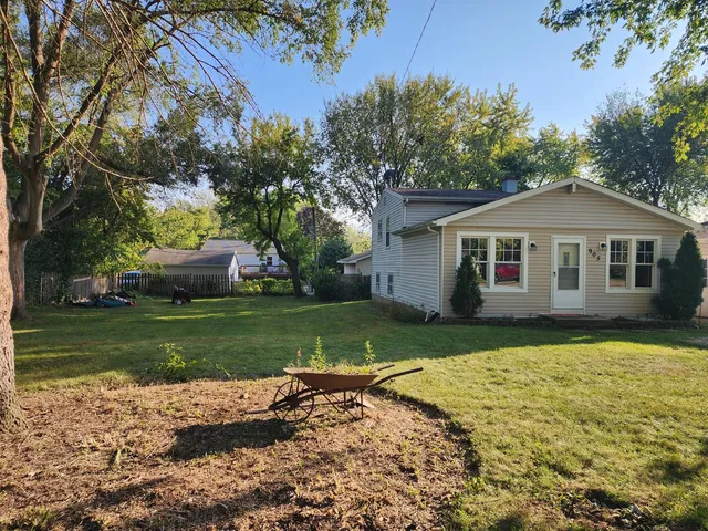 a view of a yard with a house in the background