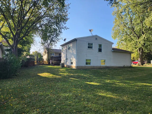 a front view of house with yard and trees