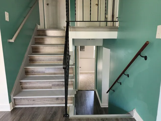 a view of entryway and hall with wooden floor