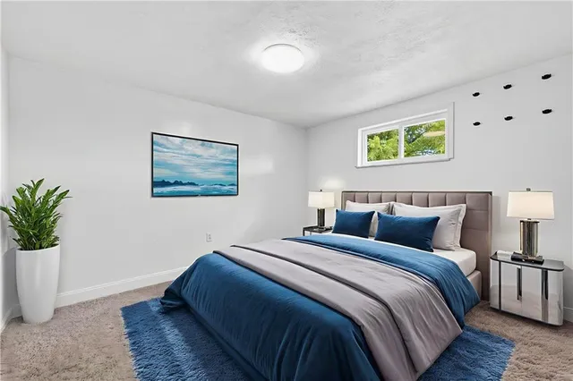 a bedroom with bed and painting on the wall