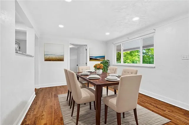 a view of a dining room with furniture and a window