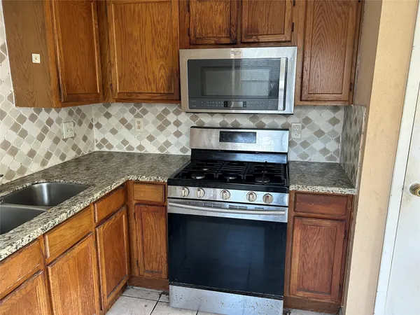 a kitchen with a stove and a microwave