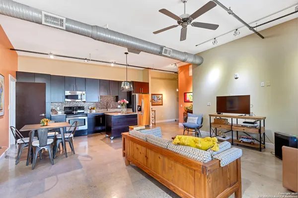 a living room with fireplace furniture and a flat screen tv