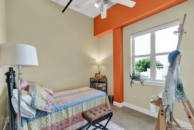 a bathroom with a granite countertop toilet sink and mirror