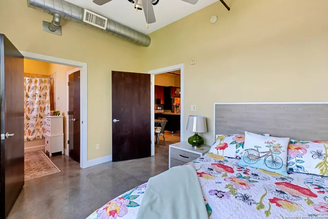 a bathroom with a granite countertop sink and a shower curtain
