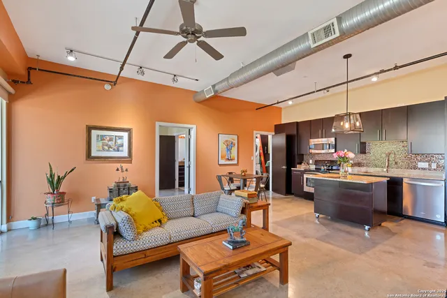 a living room with fireplace furniture and a flat screen tv