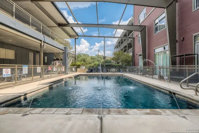 a view of swimming pool with seating area