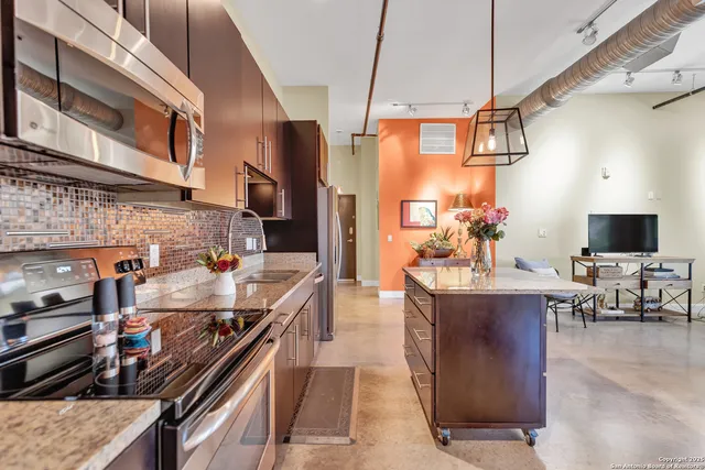 a kitchen with stainless steel appliances granite countertop a stove and a sink