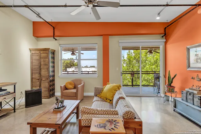 a living room with furniture and a floor to ceiling window