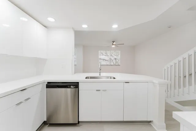 a utility room with cabinets washer and dryer