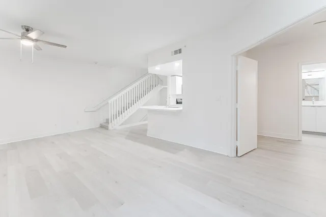 a view of a room with white walls and entryway