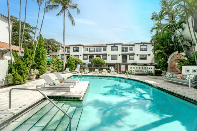 a view of house with swimming pool outdoor seating