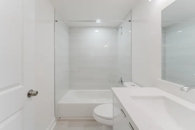 a bathroom with a sink toilet tub and shower