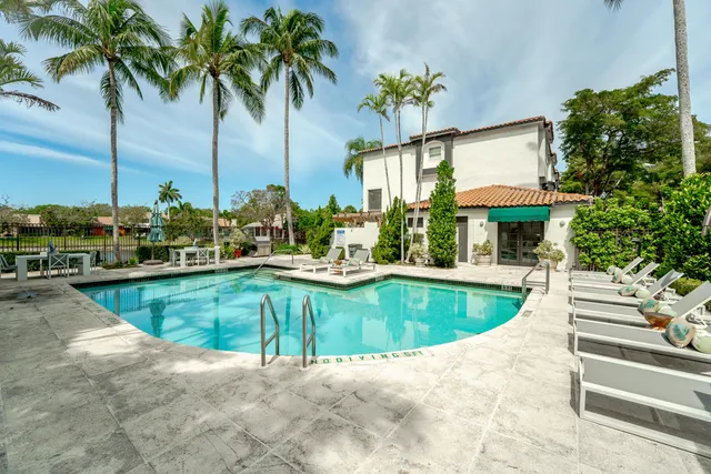 a view of a house with swimming pool and sitting area