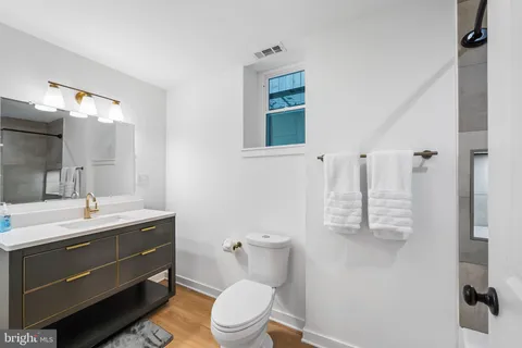 a bathroom with a toilet sink and mirror