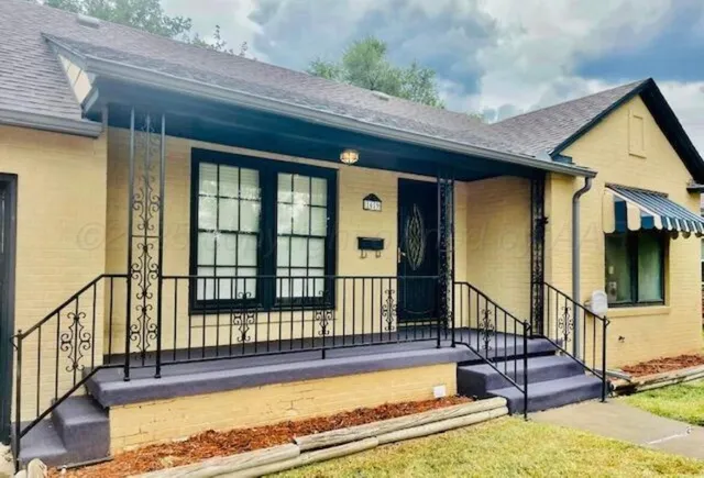 a view of a balcony with iron stairs