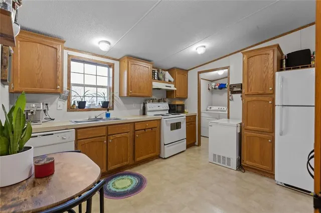 a kitchen with a refrigerator and a sink