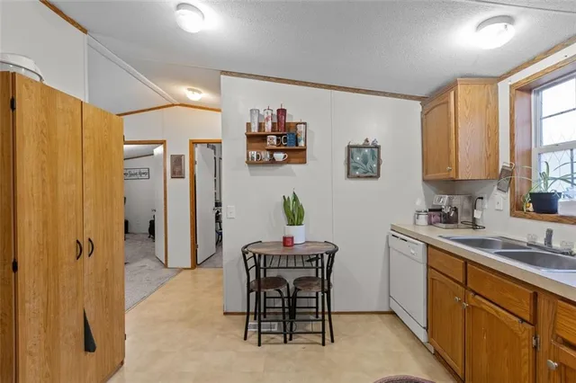 a room with a sink cabinets and wooden floor