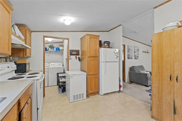 a kitchen with a refrigerator a stove top oven and a refrigerator