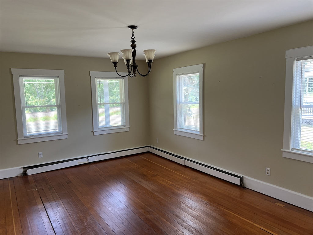 2102-2104 Palmer Road Three Rivers, MA 01080 - Photo 5 of 15 a view of an empty room with wooden floor and a window